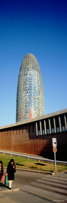 Two Women Walking near a Building, the Torre Agbar, Barcelona, Spain